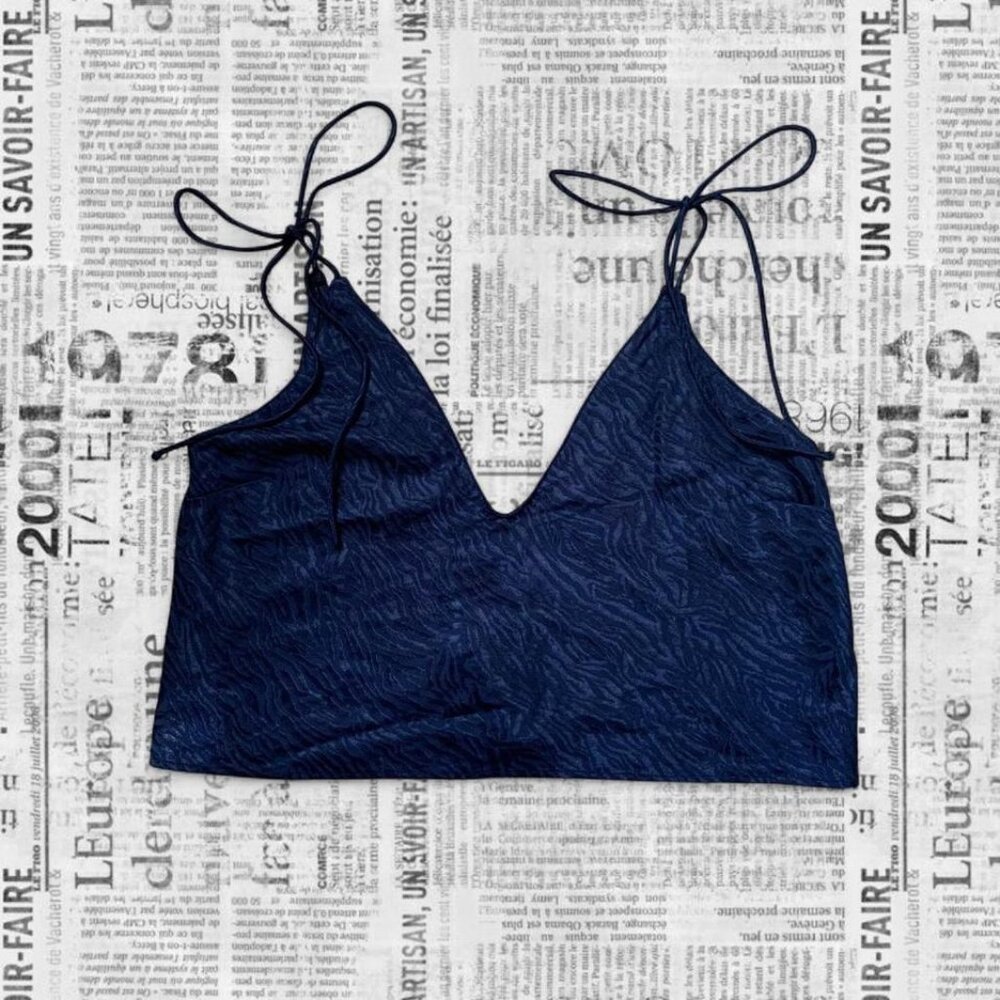 Navy blue zebra print crop top with v-neckline and adjustable tie straps